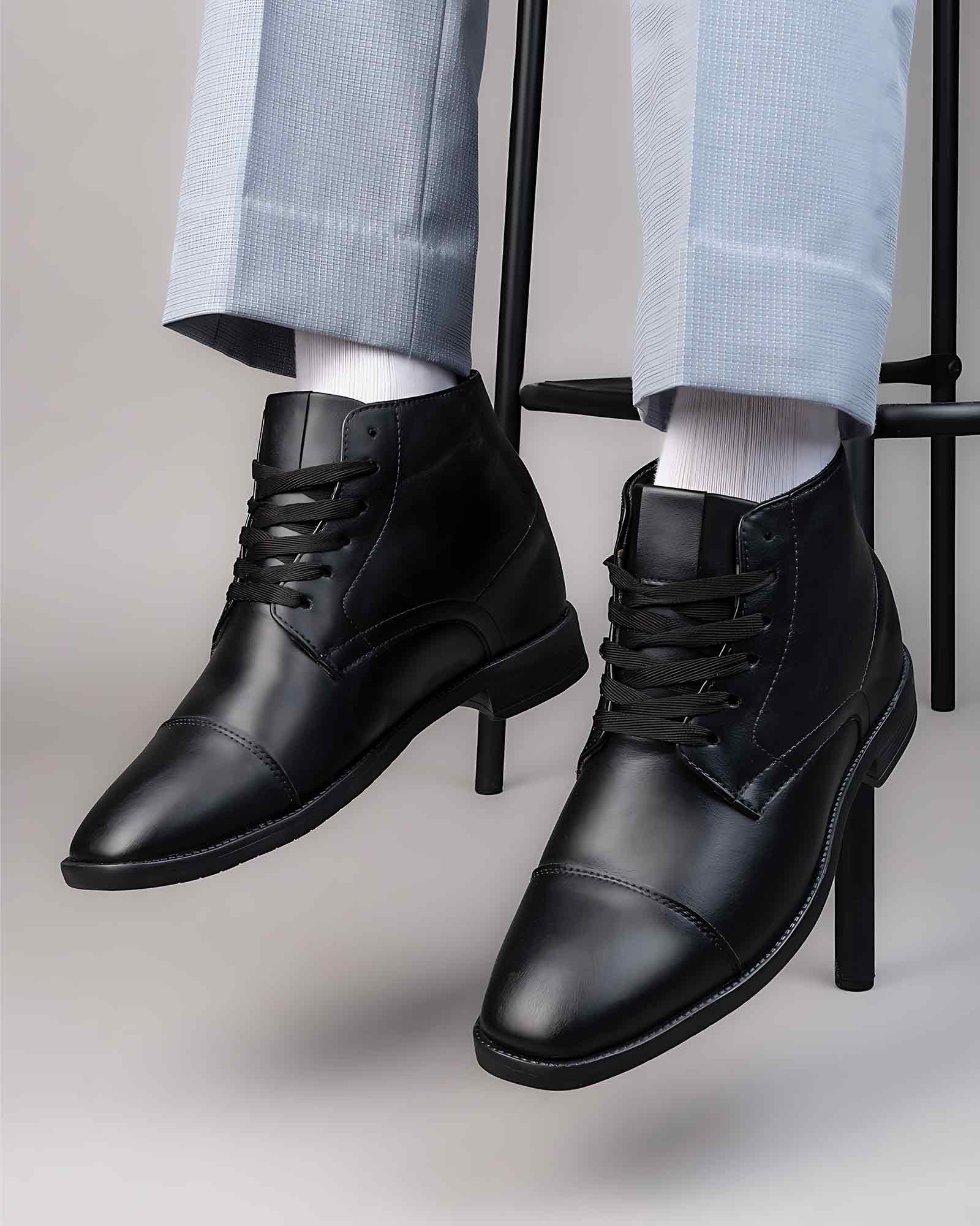 Lifestyle model wearing Hitoes Darsel black height increasing formal boots with 3 inches hidden lift