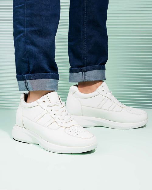 Lifestyle model wearing Hitoes Altix Trio white height increasing sneakers with 3 inches hidden lift
