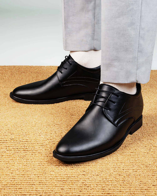Lifestyle model wearing Hitoes Denaro black height increasing formal shoes with hidden lift
