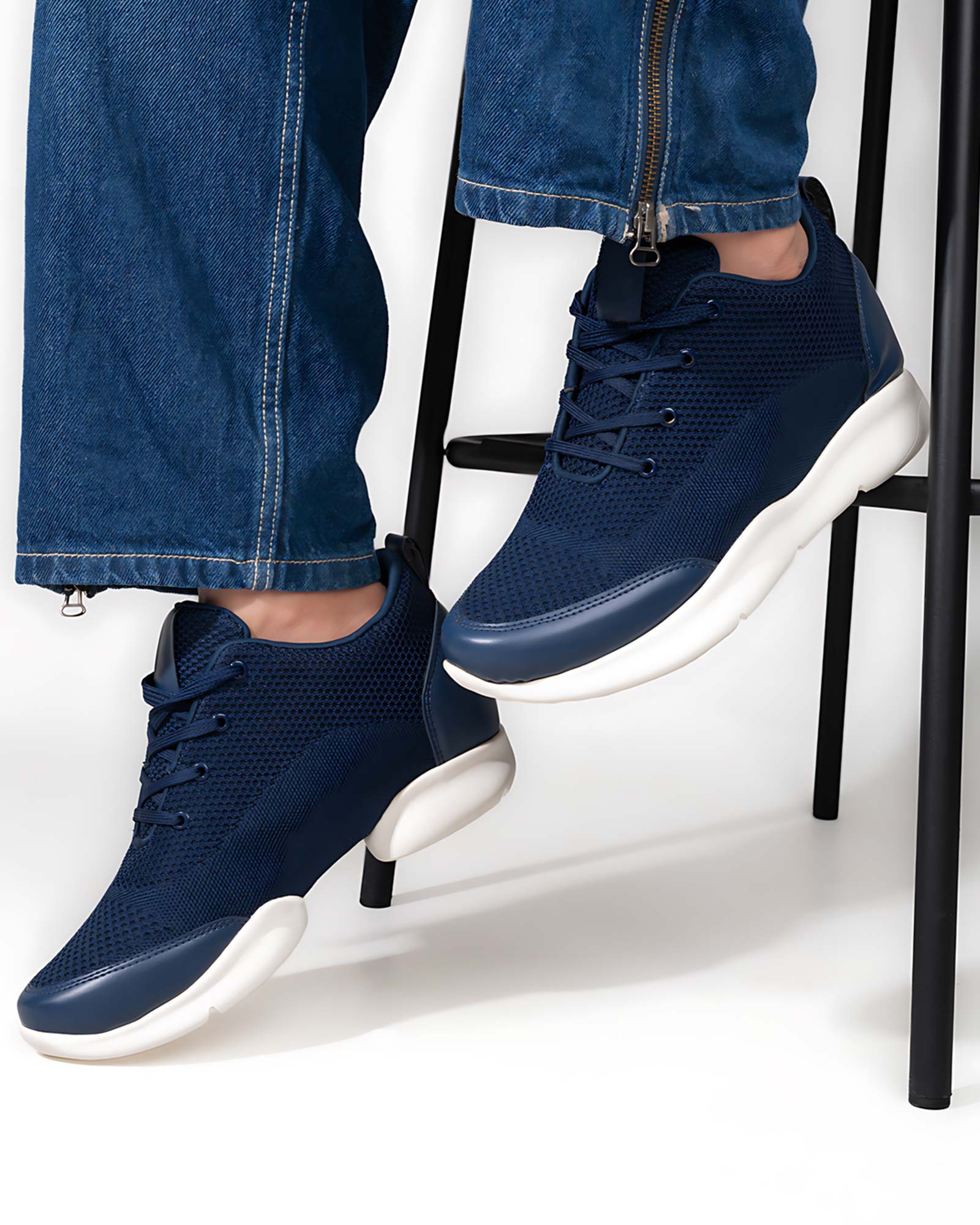 Lifestyle model wearing Hitoes Strym blue height increasing shoes with 3 inches hidden lift