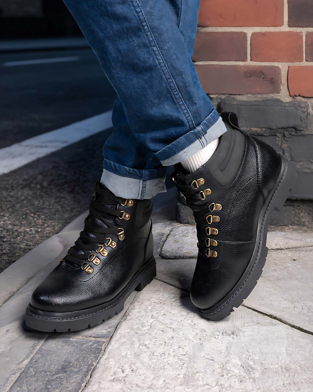 Lifestyle model wearing Hitoes Troxxon black height increasing boots with 3 inches hidden lift