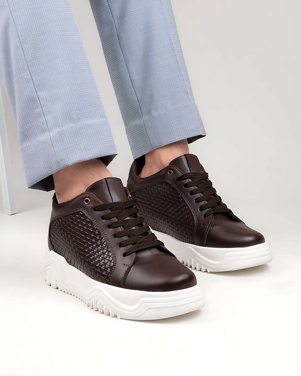 Lifestyle model wearing Hitoes Zyft Matrix brown height increasing sneakers with hidden lift